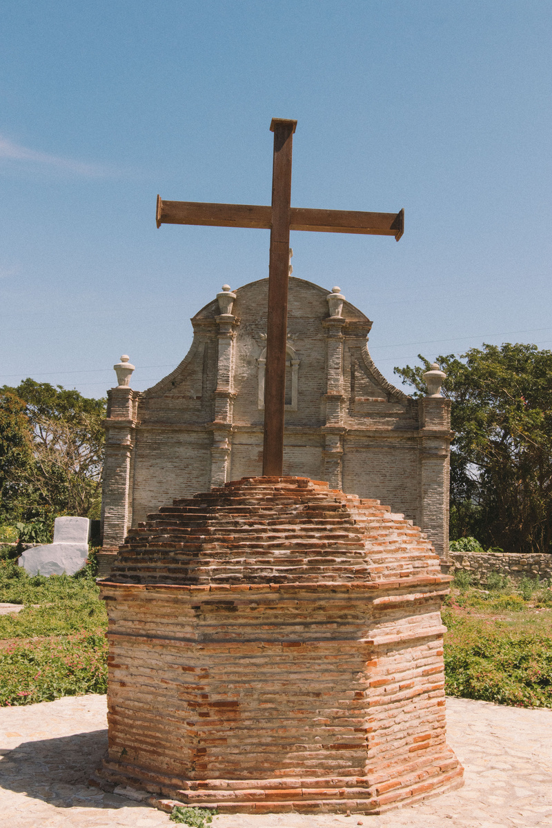 Cross in Front of an Old Church